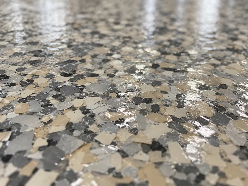 Close-up of a gray and tan flake epoxy floor